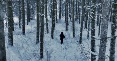 Lost hiker walking outdoors in snow storm