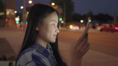 Sokaklarda akıllı telefon tableti kullanan genç bir Asyalı kadın. Yüksek kalite 4k görüntü