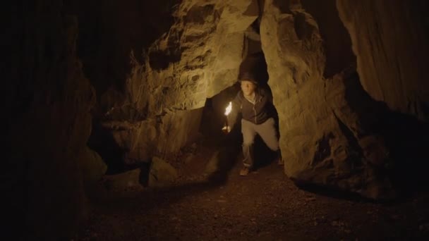 Man Holding Burning Torchlight Exploring Forest Cave Landscape Dark Night — Stok Video