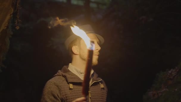 Man Holding Burning Torchlight Exploring Forest Cave Landscape Dark Night — Stok Video