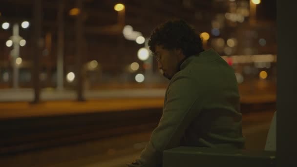One Man Black Curly Hair Waiting Lonely Train Station Night — Stock Video