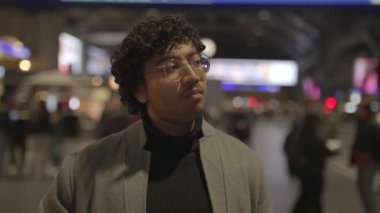Tren istasyonunda siyah kıvırcık saçlı genç adamın yaşam tarzı portresi. Yüksek kalite 4k görüntü