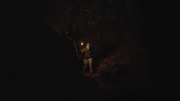Man Holding Burning Torchlight Exploring Forest Cave Landscape Dark Night — Video Stock