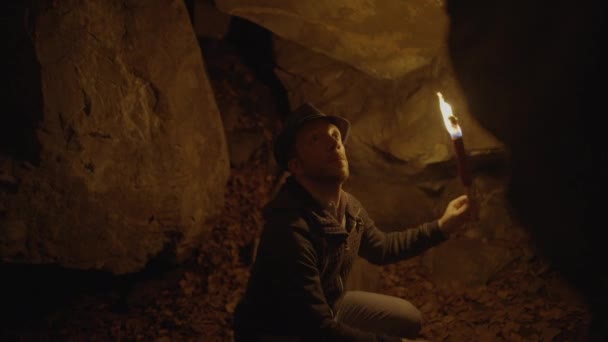 Man Holding Burning Torchlight Exploring Forest Cave Landscape Dark Night — Video Stock