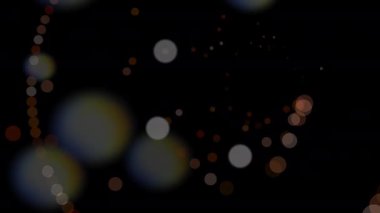 Bokeh ışıkları, daireler ve parçacıklar çeşitli kullanım alanları için soyut, şenlikli bir arkaplan oluşturuyor.