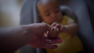 Bebek Çocuk, babasının elini tutuyor ve parmaklarına bakıyor. Yüksek kalite 4k görüntü