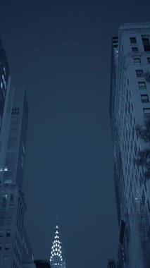 Büyüleyici bir gece manzarası, büyüleyici gökdelenleri, karanlık, yıldızlı gökyüzüne karşı canlı bir şekilde sergiliyor.