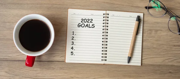 stock image 2022 GOAL with notebook, black coffee cup and pen on wood table, Top view and copy space. Happy New Year, Resolution, To do list, Strategy and Plan concept