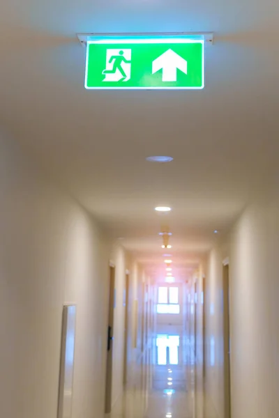 Fire Emergency exit sign on the wall background inside building. Safety concept