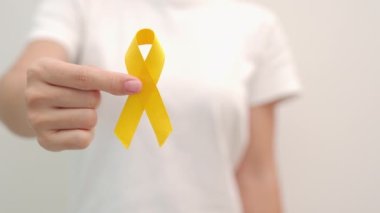 Yellow September, Suicide prevention day, Childhood, Sarcoma, bone and bladder cancer Awareness month, Yellow Ribbon for supporting people life and illness. Healthcare and World cancer day concept