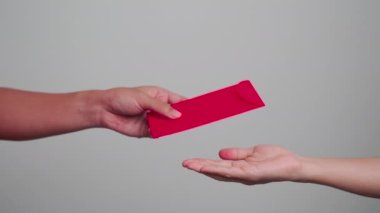 Woman holding Chinese red envelope, money gift for happy Lunar New Year holiday