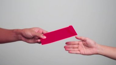 Woman holding Chinese red envelope, money gift for happy Lunar New Year holiday