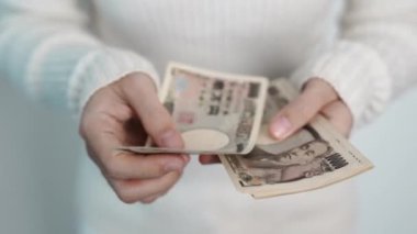 hand counting Japanese Yen banknote. Thousand Yen money. Japan cash, Tax, Recession Economy, Inflation, Investment, finance, savings, salary and payment concepts