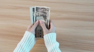 hand counting Japanese Yen banknote. Thousand Yen money. Japan cash, Tax, Recession Economy, Inflation, Investment, finance, savings, salary and payment concepts