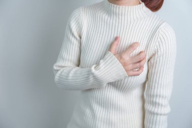 woman hand holding chest ache. Heart disease, angina disease and symptom heart attack disease Cardiovascular, Atherosclerosis, Hypertensive world Heart day and health concept