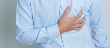 man hand holding chest ache. Heart disease, angina disease and symptom heart attack disease Cardiovascular, Atherosclerosis, Hypertensive world Heart day and health concept