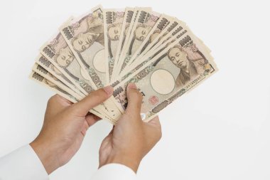 man hand holding Japanese Yen banknote stack. Thousand Yen money. Japan cash, Tax, Recession Economy, Inflation, Investment, finance and shopping payment concepts