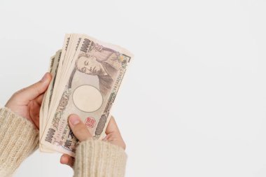 Woman hand holding Japanese Yen banknote stack. Thousand Yen money. Japan cash, Tax, Recession Economy, Inflation, Investment, finance and shopping payment concepts