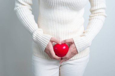 Woman holding  red heart shape. Pregnancy, Reproductive system, menstruation, and gynecology concept