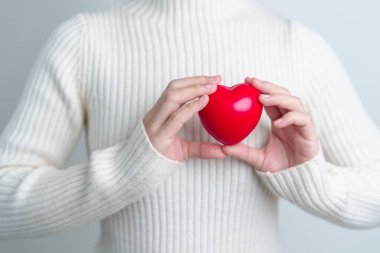 woman hand holding red heart shape. love, donor, world heart day, world health day and Insurance concepts