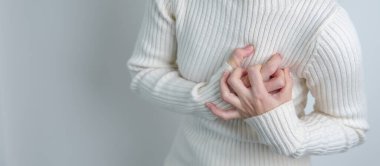 woman hand holding chest ache. Heart disease, angina disease and symptom heart attack disease Cardiovascular, Atherosclerosis, Hypertensive world Heart day and health concept