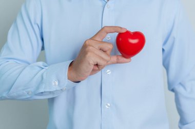 man hand holding red heart shape. love, donor, world heart day, world health day and Insurance concepts