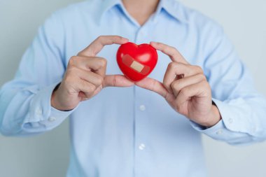 man hand holding red heart shape. love, donor, world heart day, world health day and Insurance concepts