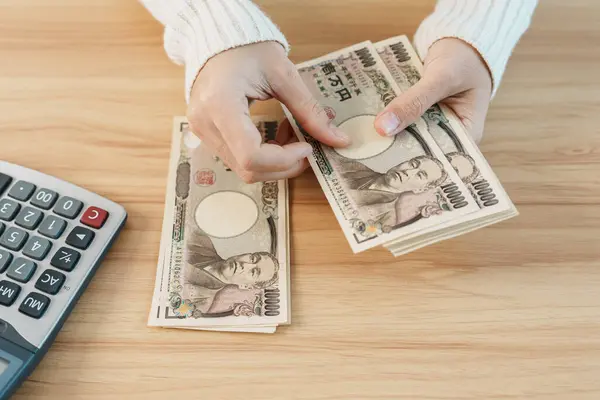 stock image Woman hand counting Japanese Yen banknote with calculator. Thousand Yen money. Japan cash, Tax, Recession Economy, Inflation, Investment, finance, savings, salary and payment concepts