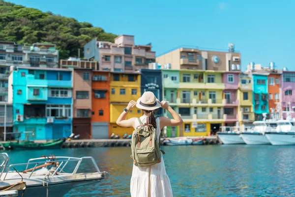 Tayvan 'ı gezen kadın gezgin, sırt çantası ve şapkasıyla Keelung' u gezen turist, Renkli Zhengbin Balıkçılık Limanı, Taipei yakınlarındaki önemli yerler. Asya Seyahat Konsepti