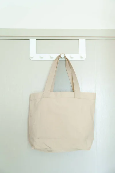 Eco friendly bag hanging on the door. Canvas Shopping tote bag. Zero waste, Reusable, Say No Plastic, Sustainability, World Environment day and Earth day concept