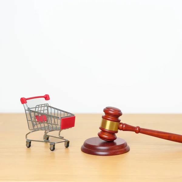 Judge gavel and small shopping cart on desk. online auction and bidding, Trade Regulations, Consumer protection Law, online shopping, E commerce, Tax, Digital, justice and judgment concept