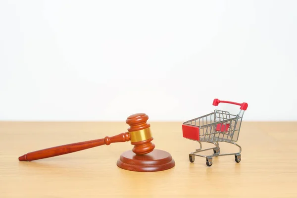 stock image Judge gavel and small shopping cart on desk. online auction and bidding, Trade Regulations, Consumer protection Law, online shopping, E commerce, Tax, Digital, justice and judgment concept