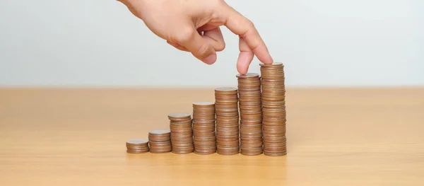 Money Saving for Future Plan, Retirement fund, Pension, Investment, Wealth, Salary and Financial concepts. hand step up coin on table, Money Counting and stack arrangement for Growth