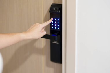 Hand press PIN number for smart digital door lock while open or close the door at home or apartment. NFC Technology, Fingerprint scan, keycard, smartphone and contactless lifestyle concepts clipart