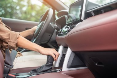 woman driver stick shift transmission a car gear, hand controlling steering wheel during vehicle moving. Journey, trip and safety Transportation concepts