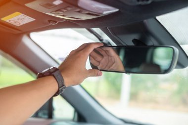 man driver adjusting rear view mirror a car. Journey, trip and safety Transportation concepts