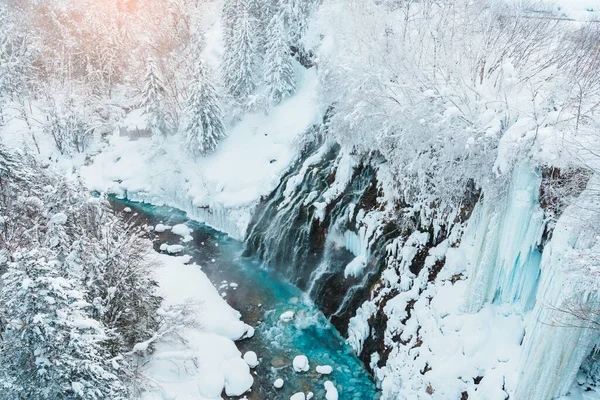 stock image Shirahige Waterfall with Snow in winter, Biei river flow into Blue Pond. landmark and popular for attractions in Hokkaido, Japan. Travel and Vacation concept