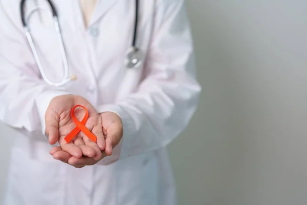 stock image Orange Ribbon for Leukemia, Kidney cancer day, world Multiple Sclerosis, CRPS, Self Injury Awareness month. Healthcare and word cancer day concept