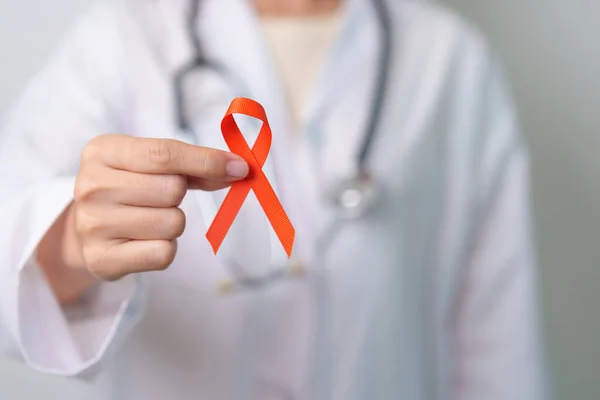 stock image Orange Ribbon for Leukemia, Kidney cancer day, world Multiple Sclerosis, CRPS, Self Injury Awareness month. Healthcare and word cancer day concept