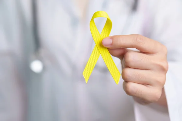 stock image Yellow September, Suicide prevention day, Childhood, Sarcoma, bone and bladder cancer Awareness month, Yellow Ribbon for supporting people life and illness. Healthcare and World cancer day concept