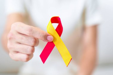 woman holding Red and Yellow ribbon. World hepatitis day awareness month, 28 July, Liver cancer, Jaundice, Cirrhosis, Failure, Enlarged, Hepatic Encephalopathy and Health concept clipart