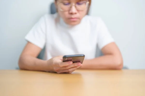 stock image Casual woman holding and using smartphone for sms messages, young woman typing touchscreen mobile phone. lifestyle, technology, Social media and network concept