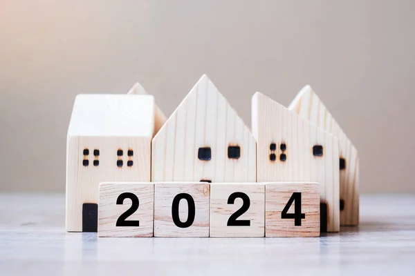 stock image 2024 Happy New Year with house model on table wooden background. Banking, real estate, investment, financial, savings and New Year Resolution concepts