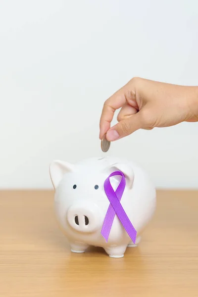 Purple Ribbon with Piggy Bank for Pancreatic, Esophageal, Testicular cancer, world Alzheimer, epilepsy, lupus, Sarcoidosis, Fibromyalgia and domestic violence Awareness month. World cancer day concept
