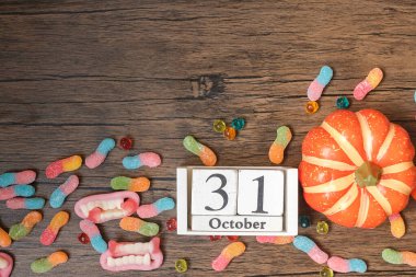 Happy Halloween day with ghost candies, pumpkin,  bowl and 31 October calendar. Trick or Threat, Hello October, fall autumn, Festive, party and holiday concept