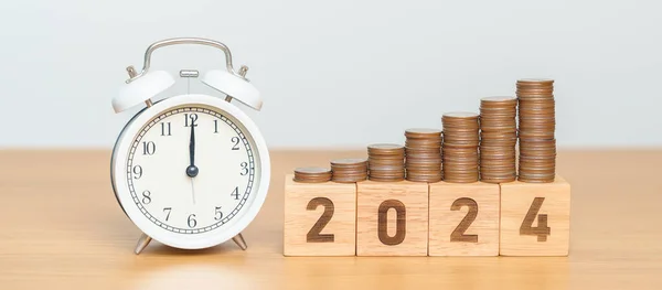 Happy New Year with vintage alarm clock and flipping 2023 change to 2024 block. Resolution, Goals, Plan, Action, Money Saving, Retirement fund, Pension, Investment and Financial concept