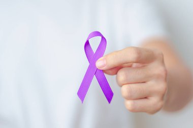 Şiddet, Pankreas, Özofagus, Testis kanseri, Alzheimer, epilepsi, lupus, Sarkoidoz ve Fibromiyalji için mor kurdele tutan kadın. Farkındalık ayı ve Dünya Kanser Günü konsepti