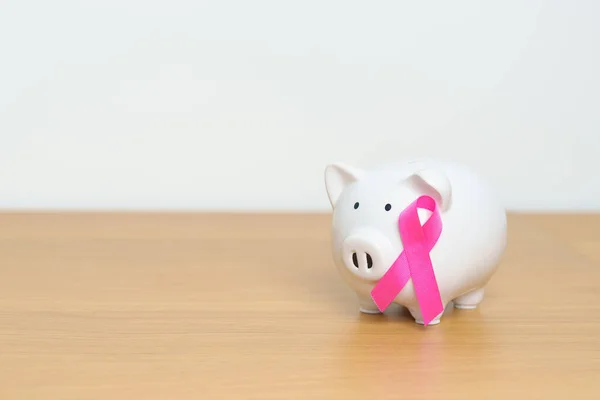 October Breast Cancer Awareness month, Pink Ribbon with Piggy Bank for support illness life. Health, Donation, Charity, Campaign, Money Saving, Fund, women day and World cancer day concept