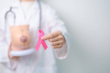 Pembe Ekim Göğüs Kanseri Bilinci Ayı, pembe kurdele ve göğüs anatomisi modeli olan doktor kadın. Ulusal kanser kurtulanlar ayı, sağlık teşhisi, Anne ve Dünya Kanser Günü konsepti