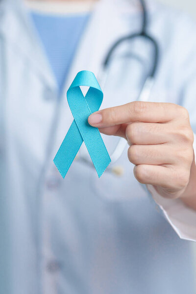 Blue November Prostate Cancer Awareness month, Doctor with Blue Ribbon in hospital for support people life and illness. Healthcare, International men, Father, Diabetes and World cancer day